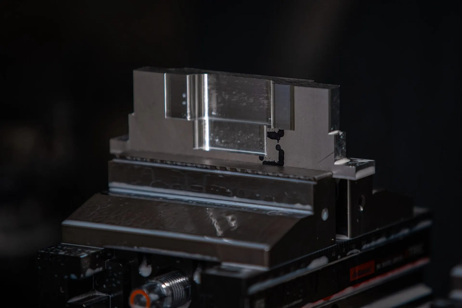 Precision machined aluminium part held in a vice during CNC manufacturing in Chatteris